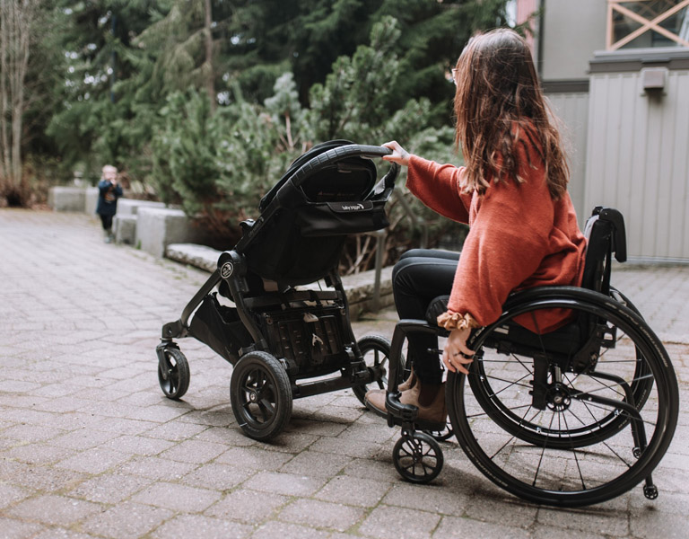 Reedan in her APEX C pushing her youngest son in a stroller 